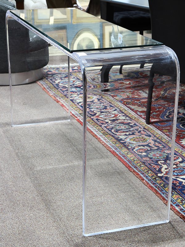 Moderne acrylic console table: Moderne acrylic console table, having an inset glass top, above the contoured base, 30"h x 58.5"w x 16"d