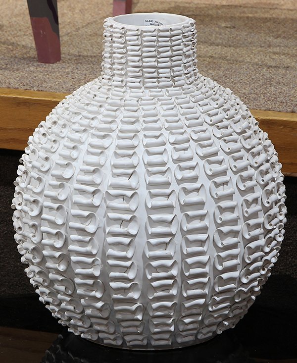Moderne pottery vase, having a stick neck above the: Moderne pottery vase, having a stick neck above the bulbous body, decorated with scrolled accents, 17.5"h