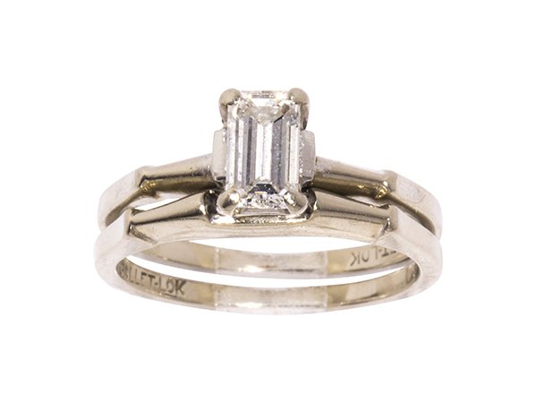 Diamond and 14k white gold wedding set: Diamond and 14k white gold wedding set featuring (1) emerald cut diamond weighing approximately 0.55 ct., set in a shouldered engagement ring mounting, together with a matching conforming Balletlok ba