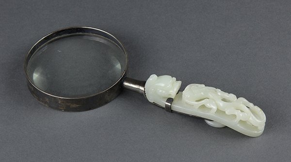 Chinese Jade Magnifying Glass: Chinese magnifying glass with jade belt hook handle, pierced and carved with a chilong confronting a dragon, executed from an off-white matrix, the rim of the magnifying glass reads 'Atco, USA', jade: