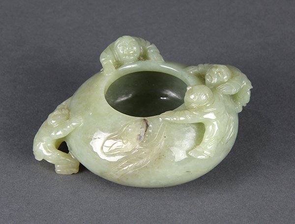 Chinese Jade Brush Washer, Children: Chinese celadon jade brush washer, featuring four children climbing onto the compressed globular body, the celadon matrix with dark flecks and icy inclusions, 4.25"w