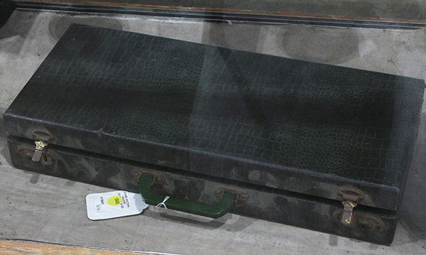 Cased Mahjong set: Cased Mahjong set, having carved bone and green Bakelite tiles, Bakelite counters and (4) Bakelite racks, all in a faux alligator rectangular care, 3"h x 19.5"w x 9.5"d. Provenance: Property from the