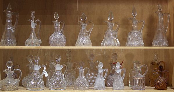 Two shelves of pressed glass table cruets, circa 1900, (1 of 1)