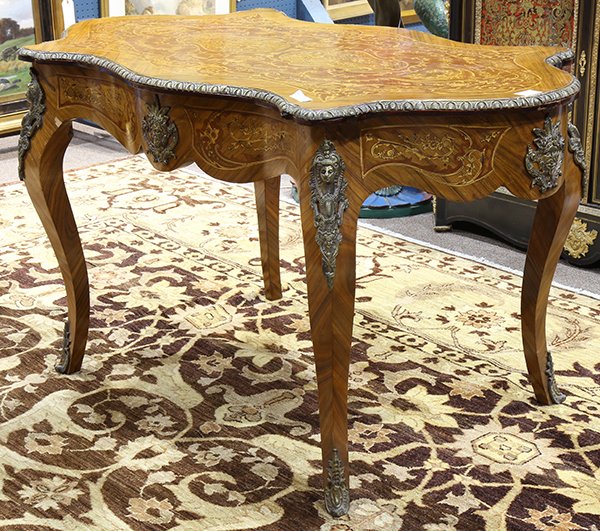 Louis XV style marquetry decorated bureau plat: Louis XV style marquetry decorated bureau plat, having a turtle top with inlaid and painted Neoclassical accents, surmounting a wide apron with one drawer and applied gilt brass masks, the whole risin