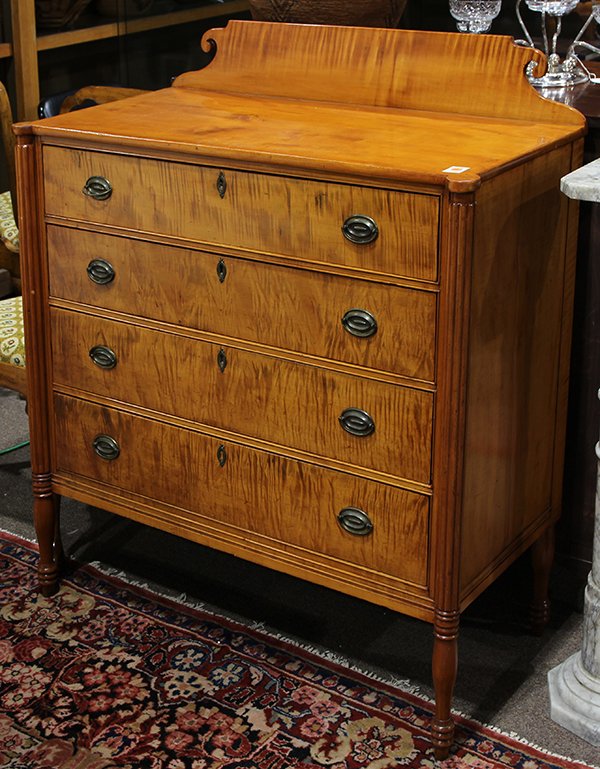 Sheraton tiger maple chest: Sheraton tiger maple chest, circa 1800, having a scrolled crest above a turreted top, the rectangular case with four graduated drawers divided by cock beaded stiles and flanked by reeded pilasters con