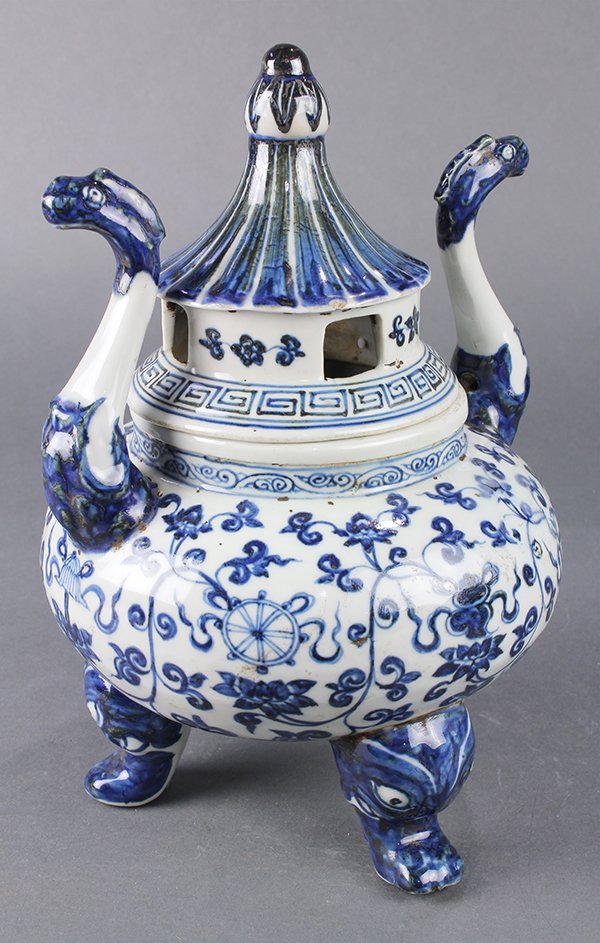 Chinese Blue and White Censer: Chinese underglaze blue porcelain covered censer, with tendrils and Eight Buddhist Treasures to the compressed body, raised on three beast formed supports, 'S' shaped handles flank the shoulder, lid i