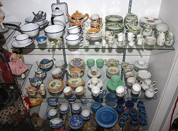 Three shelves of associated children's china sets, (1 of 5)