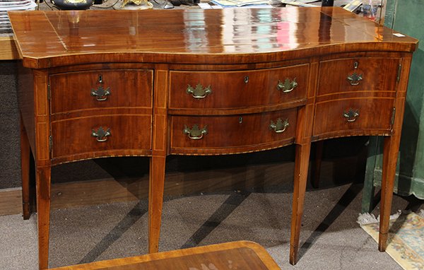 Federal band inlaid sideboard: Federal band inlaid sideboard, circa 1800, having a shaped top above the two drawer case, and rising on tapered legs, 39"h x 62.5"w x 28"d. (key in office)