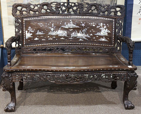 Chinese Mother-of-Pearl Inlaid Settee: Two Chinese mother-of-pearl inlaid wooden settees, the rails pierced with a pair of dragons above the backs inlaid with scenes of seven scholars in a landscape, the dragon form arms frame the shaped s