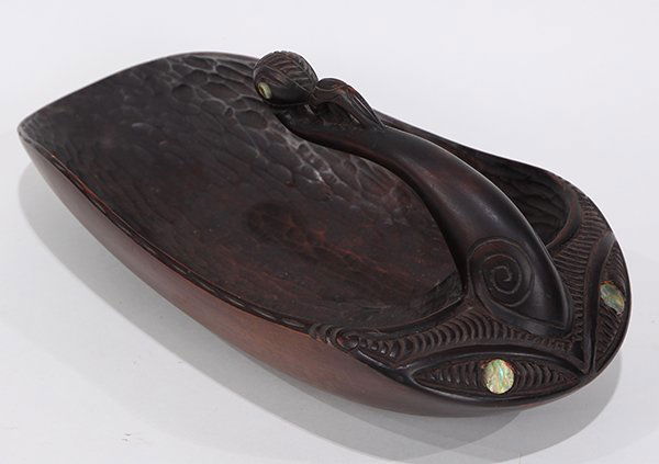 Maori tribal feast bowl: Maori tribal feast bowl, the base carved and handle inlaid with abalone, 13"l. Provenance: Property from the Christian DeGuine' IV Estate, Hillsborough, CA.