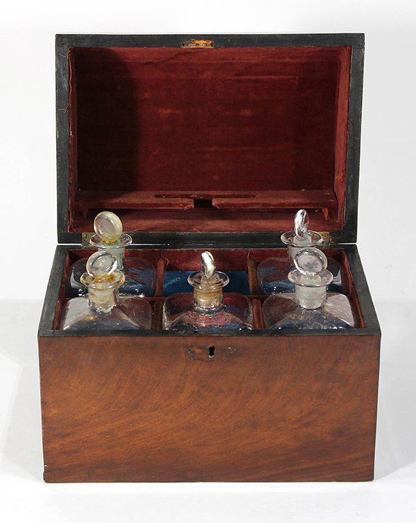 English brass and mahogany decanter case, 19th century,: English brass and mahogany decanter case, 19th century, the dome top opening to a fabric lined fitted interior with five gilt decorated stoppered decanters, 9.5"h x 10.5"w x 7"d. Provenance: Property