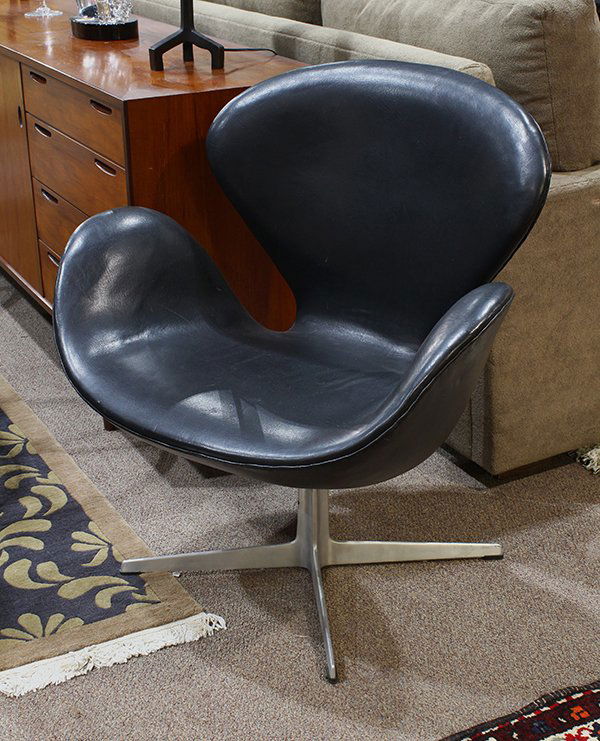 Arne Jacobsen (1902-1971) for Fritz Hansen Swan chair: Arne Jacobsen (1902-1971) for Fritz Hansen Swan chair, executed in black leather, and rising on an aluminum X-form base, 32"h x 30"w x 19.5"d