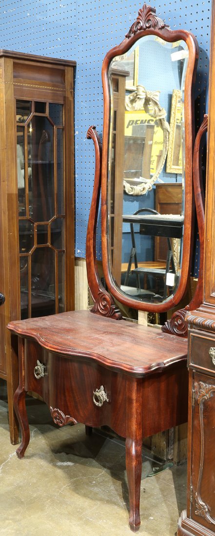 Empire style mahogany vanity, having an adjustable: Empire style mahogany vanity, having an adjustable mirror, above a shaped top, continuing to a single drawer case, and rising on cabriole legs, 69"h x 32"w x 18"d