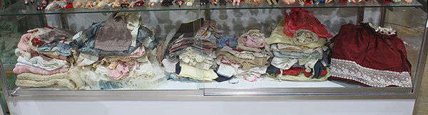 One shelf of doll clothes inlcuding period linen and (1 of 1)