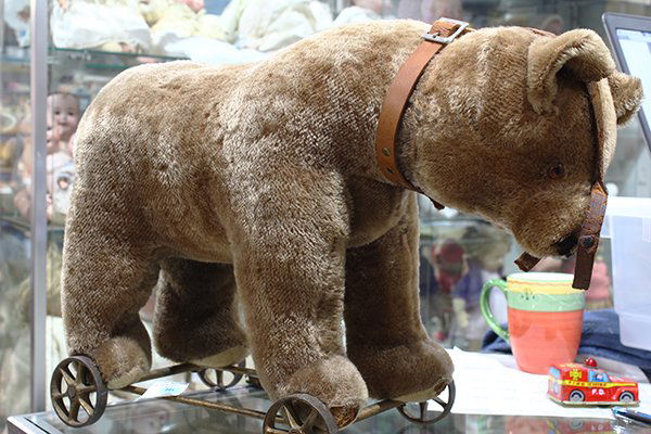 Early Steiff mohair bear on wheels, wearing a brown (1 of 1)