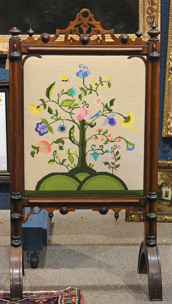 Victorian Gothic needlepoint fireplace screen: Victorian Gothic needlepoint fireplace screen, having a pierced and scalloped cornice, with turned spire finials, surrmounted a framed needlepoint of a flowering sweet pea plant on a white ground, ris