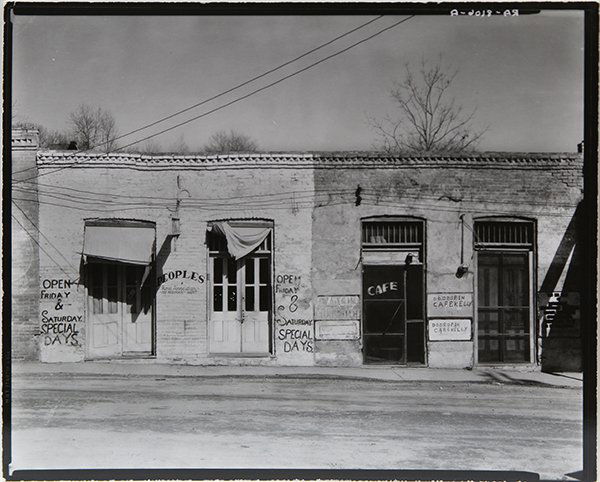 Photograph, Walker Evans: Walker Evans (American, 1903-1975), "Storefronts, Edwards, Mississippi," (1936), gelatin silver print, unsigned, artist stamp verso, image: 7.5"h x 9.5"w, sheet: 8"h x 10"w, overall (with mat): 14"h x
