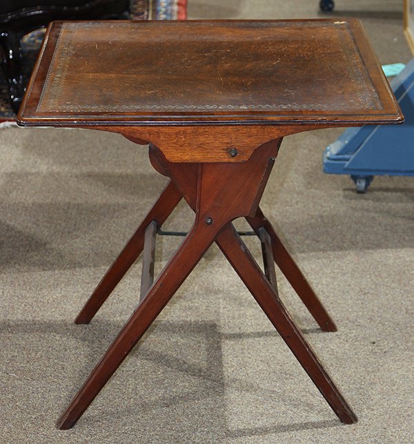 English campaign style folding coaching table, 19th: English campaign style folding coaching table, 19th century, having a square leather top with a tooled border, folding to reveal the lower box, and rising on an X form base, 27.5"h x 27"w. Provenance:
