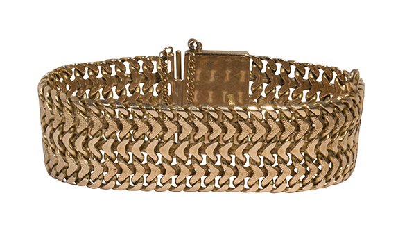 18k yellow gold bracelet: 18k yellow gold bracelet the wide textured woven chevron link, measures approximately 23.0 mm in width, completed by a wide large clasp, with a safety chain and figure eight safety forming a 7 1/2" br