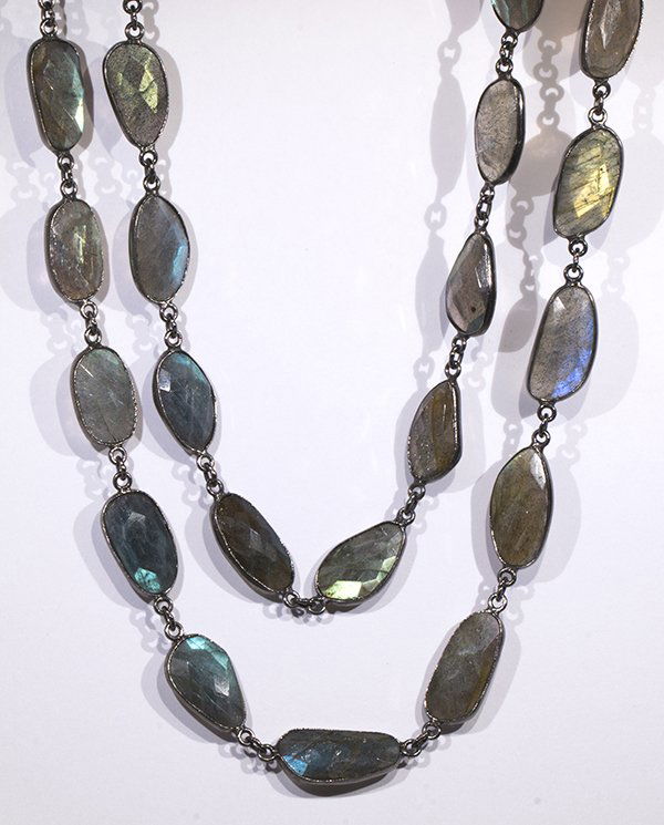 Labradorite and sterling silver necklace: Labradorite and sterling silver necklace composed of (36) oval double rose cut labradorites measuring approximately 20.5 x 8.7 mm to 16.6 x 8.5 mm, bezel set and linked in sterling silver, forming a n