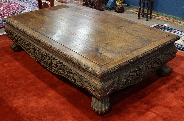 Thai Wooden Platform Bed: Thai carved wooden bed, the top set with four floating panels within an edge and waist decorated with floral tendrils, the shaped apron elaborately carved with a deity, makura, lotus and egrets, raise