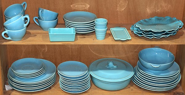 (lot of approx 50) American art pottery group,: (lot of approx 50) American art pottery group, executed in teal, by various makers such as Catalina and Franciscan, including tea cups and saucers, a butter dish, serving pieces, luncheon plates, and