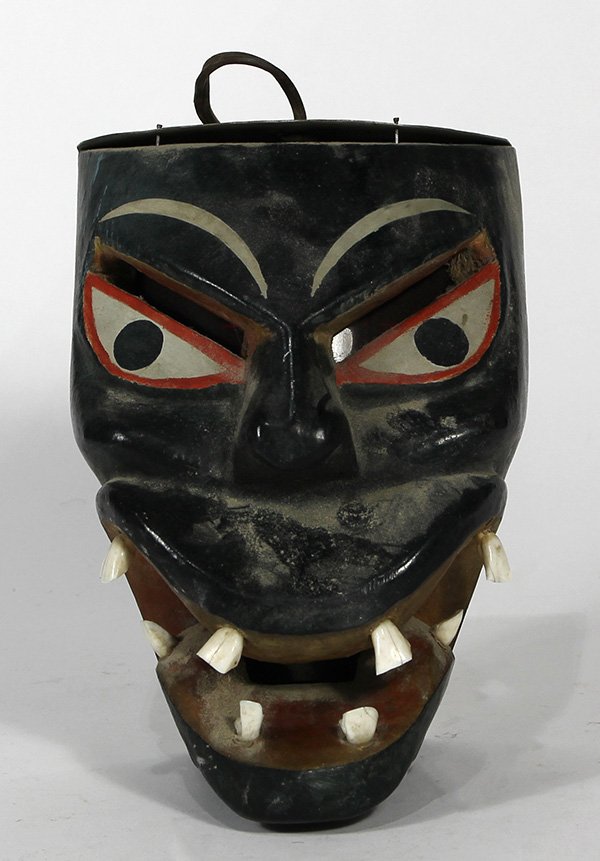 Indonesian style decorative mask: Indonesian style decorative mask, having polychrome stylized details, and mouth opening to reveal a set of teeth, 10"l