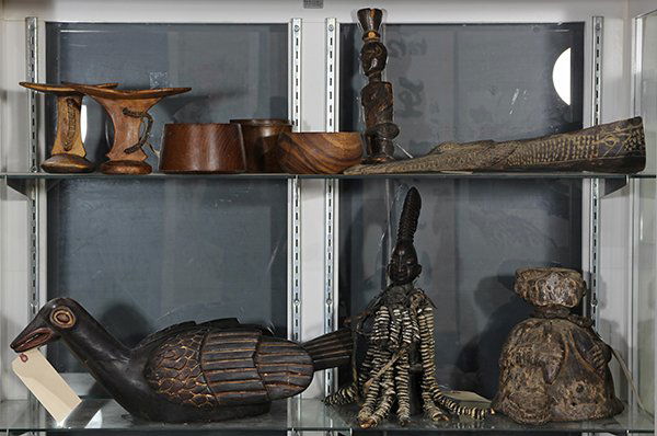 (lot of 10) West African carved wood decorative objects: (lot of 10) West African carved wood decorative objects including a Yoruba style fetish mounted with cowrie shells, head rests, bird sculpture; together with turned wood bowls, and an Indonesian figur