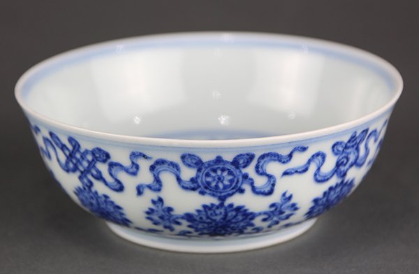 Chinese Blue and White Porcelain Bowl: Chinese underglaze blue porcelain shallow bowl, the exterior with Buddhist Treasures above lotus scrolls, the interior with gourd vines, and the recessed base with an apocryphal Qianlong mark, 5"w