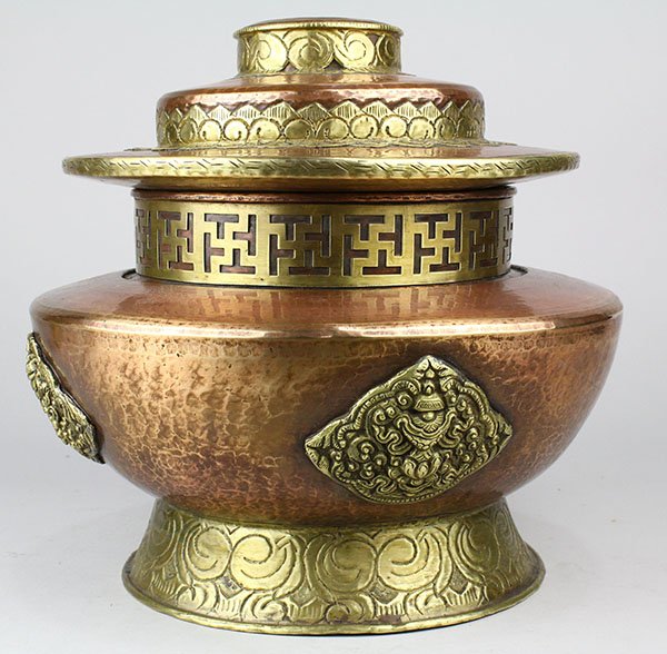 Tibetan Covered Copper Bowl: Tibetan copper lidded bowl, with Buddhist Treasures in reserves on a circular support, together with a stepped lid, overall: approx 12"dia x 10.5"h
