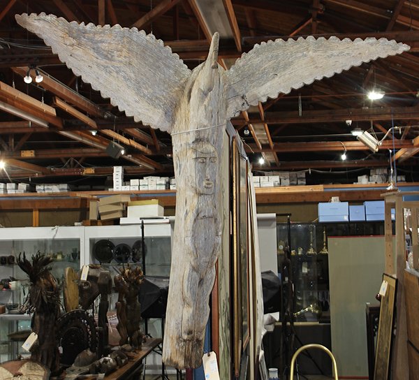 Ethnographic carved totem surmounted by a bird and: Ethnographic carved totem surmounted by a bird and having a male figure, 49"h.