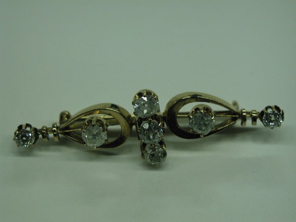 14K YELLOW GOLD AND DIAMOND ANTIQUE BAR PIN: **14K YELLOW GOLD AND OLD MINE CUT DIAMOND, "RUSSIAN" ANTIQUE BAR PIN; (7) diamonds, total weight approximately 2.00 cts. 3.4 DWT. $1,800 - 2,250