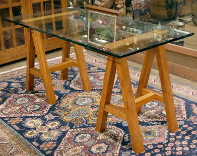 Glass top table, saw horse: Contemporary glass top table with teak saw horse base (60''W x 30.5''H x 30''D)