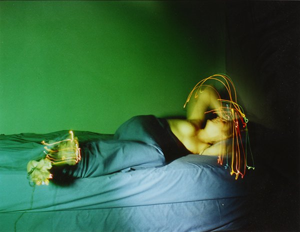 Photograph, Jimmy DeSana: Jimmy DeSana (American, 1950-1990), "Figure with Light Trails in Bed," cibachrome print, artist stamp verso, edition: 8/28, image: 16"h x 20"w, overall (with frame): 24"h x 28"w. Note: A similar work