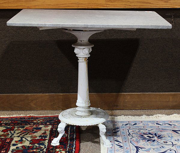 Cast iron table, having a rectangular gray stone top on (1 of 3)