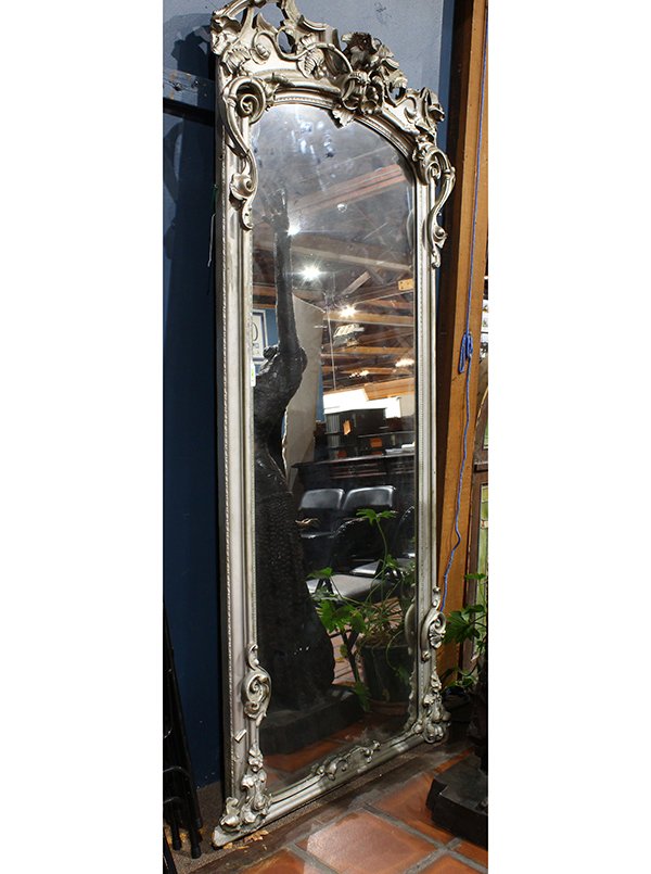 Monumental Rococo style silvered mirror, having a (1 of 2)
