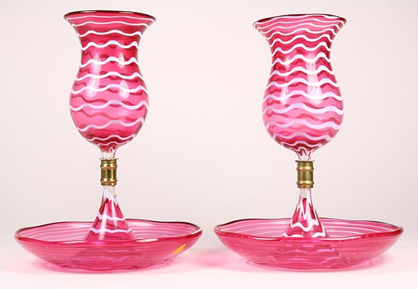 Pair of cranberry glass epergnes, each with one-stem,: Pair of cranberry glass epergnes, each with one-stem, the lower bowl having a conical center issuing to a brass fitting surmounted with a cranberry vase, 10"h x 8"dia.