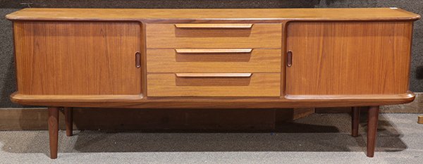 Danish Modern teak credenza: Danish Modern teak credenza, having a rectangular top, above the case with three drawers and two tambour doors, and rising on tapered cylindrical legs, 27.5"h x 78"w x 17.5"d