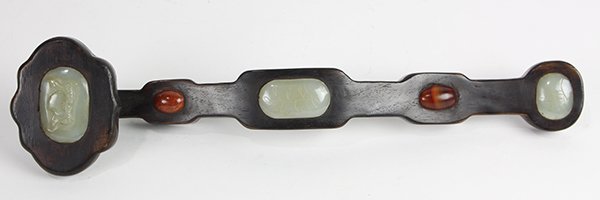 Chinese Stone Inlaid Wood Ruyi Scepter: Chinese stone inset wooden ruyi scepter, with three celadon green plaques with peach and foliage, and agate cabochon, 16.75"w