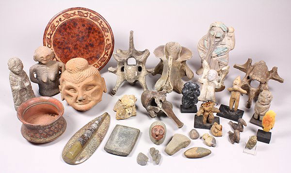 Two shelves of Pre-Columbian style pottery, stone and: Two shelves of Pre-Columbian style pottery, stone and bone decorative objects, including figural groups, largest: 8.5"dia.