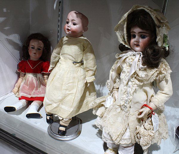 (Lot of 3) German and French bisque dolls, each in: (Lot of 3) German and French bisque dolls, each in vintage clothes with lace accents, including a German antique bisque socket head doll by Armand Marseille, the hand-decorated face having feathered e