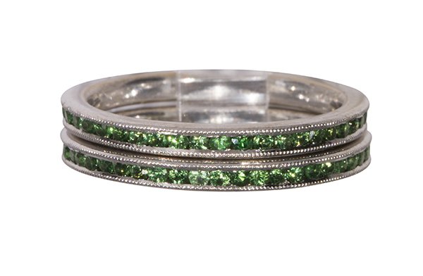 (Lot of 2) Matching Simon G tsavorite, garnet and 18k: (Lot of 2) Matching Simon G tsavorite, garnet and 18k white gold eternity bands each band is set with (45) round cut tsavorite garnets weighing a total of approximately 0.55 ct., in 18k white gold, 2.