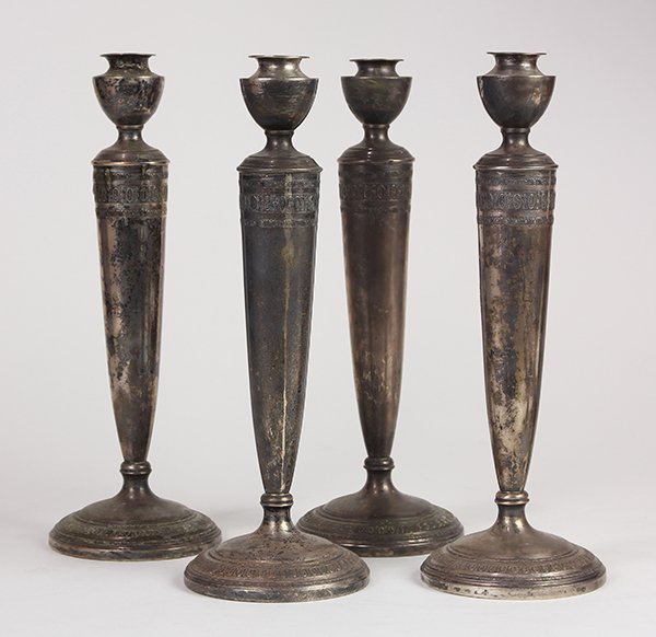 (lot of 4) American Clarence Vanderbilt weighted: (lot of 4) American Clarence Vanderbilt weighted sterling silver candle holders, each of a Neo-Classical style accented with stylized bands, 11.5"h. Provenance: Property from the collection of Trott