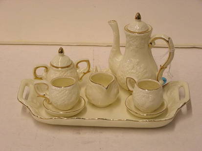 Miniature porcelain chocolate service: Miniature porcelain chocolate service including lidded teapot sugar, creamer, two teacups & saucers, on tray