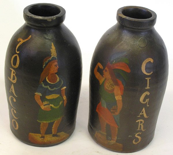Brown jugs: Pair of brown glazed jugs with later painting of cigar store Indians, drilled for lamps, 9.75''h