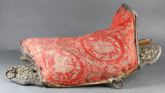 Chinese Iron and Wood Saddle: Chinese iron and wooden saddle, with a pieced wood construction with iron fittings featuring reticulated dragons in pursuit of a jewel amid scrolls, with a red silk brocade to the padded seat, 22.25"w