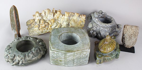 Three Shelves of Chinese Hardstone Archaistic Items: (lot of 29) Three shelves of Chinese hardstone archaistic decorative items, including animal and figural carvings, wine vessels, cong, and hair ornament, and a box of blades, largest: 10.25"h. Provena