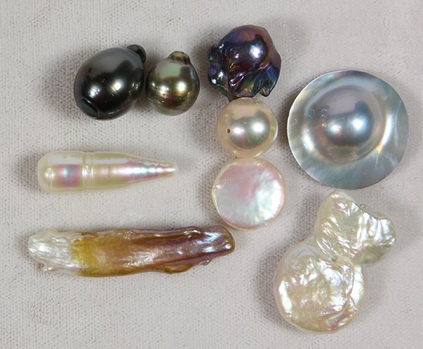 Collection of loose baroque cultured pearls: Collection of loose baroque cultured pearls comprised of 4 Tahitian black/gray cultured pearls, ranging in size from approximately 18.5 x 16.5 mm to 15.5 x 14.6 mm; together with numerous baroque butt