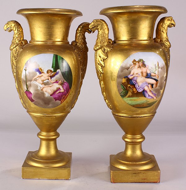 Pair of Royal Vienna or KPM style porcelain and gilt: Pair of Royal Vienna or KPM style porcelain and gilt urns, each having gilt accented eagle form handles, flanking a central reserve of classical nude figures, and rising on a square base, 15"h x 7"dia