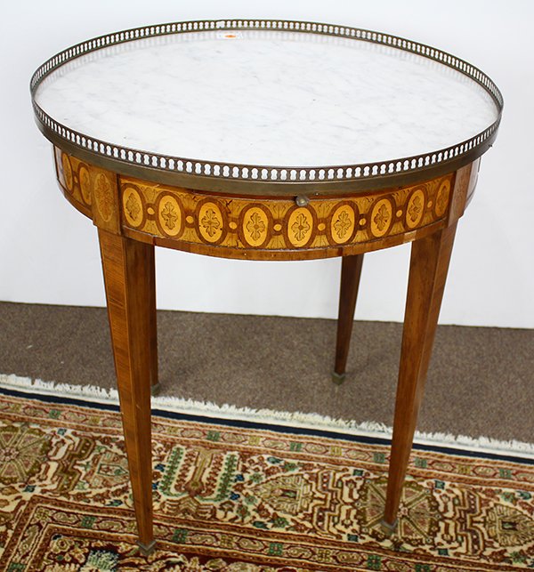French Louis XV style inlaid gueridon, 19th century,: French Louis XV style inlaid gueridon, 19th century, having a marble top with brass gallery, above a fitted inlaid apron with a repeating motif of acanthus and oval medallions, rising on square taperi